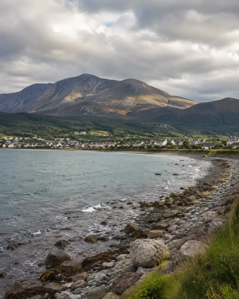 Newcastle beach and promenade with the Mourne Mountains meeting the sea